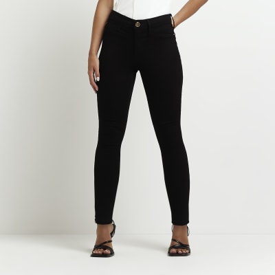 Petite black Molly mid rise skinny jeans | River Island