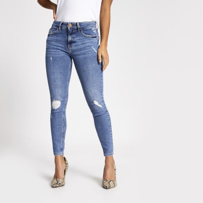 Petite blue ripped Amelie super skinny jeans | River Island