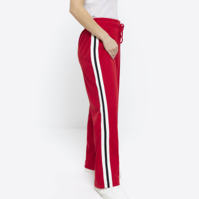 Petite red side stripe wide leg joggers River Island