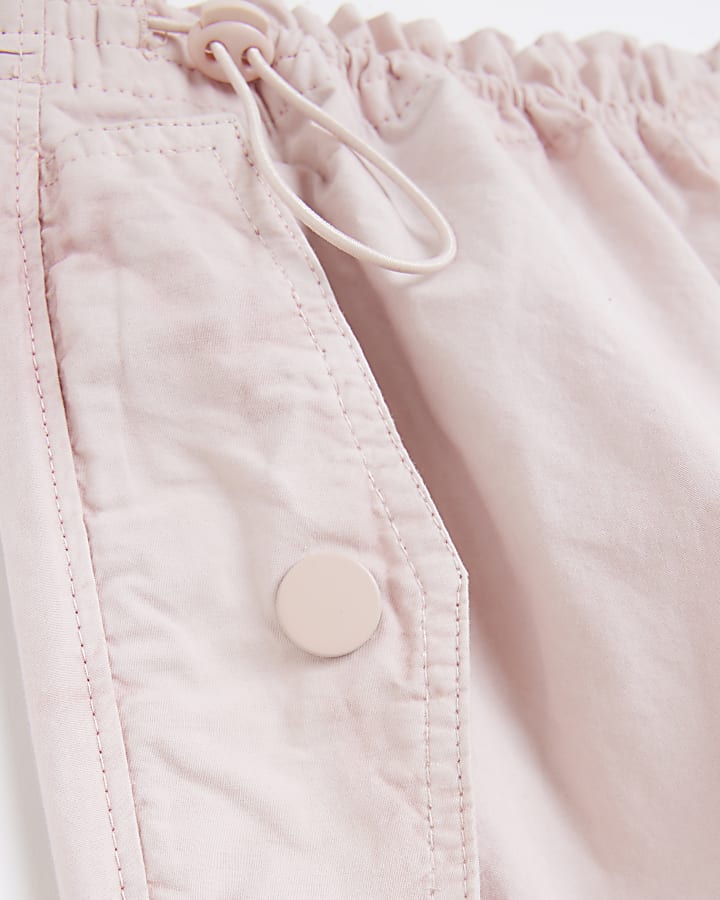 Pink low rise parachute trousers