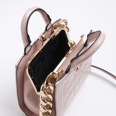 Pink quilted clip top cross body bag River Island