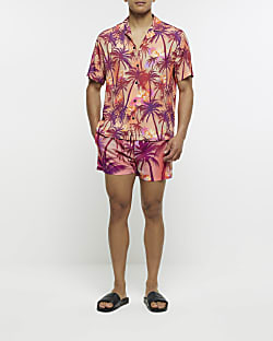 Pink regular fit palm print swim shorts