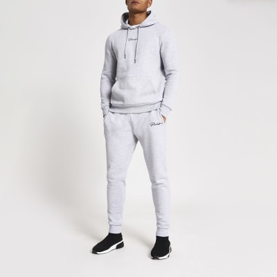 grey joggers and hoodie