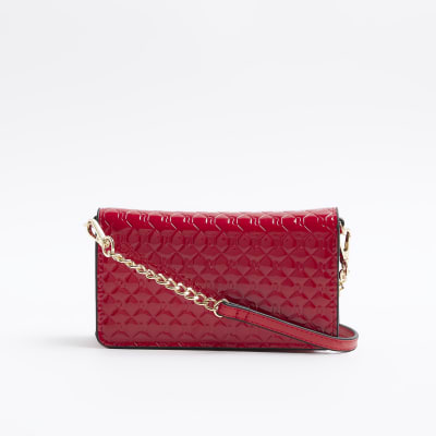 Red embossed cross body purse | River Island