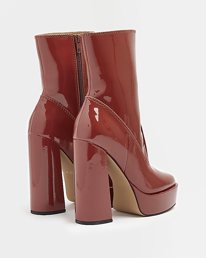 Red patent platform heeled ankle boots