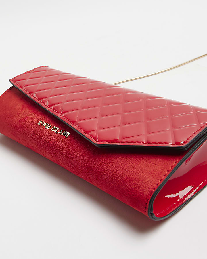 Red quilted asymmetric clutch bag