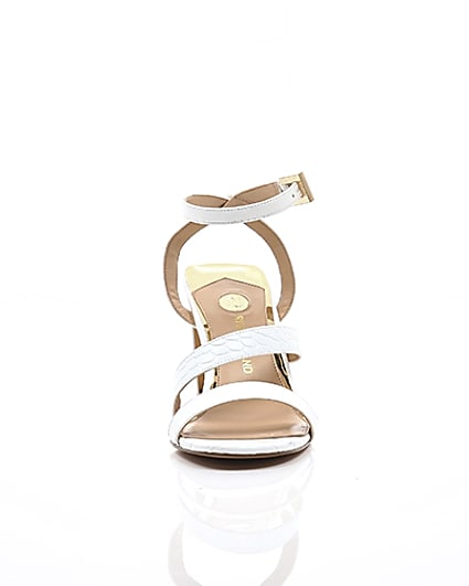 360 degree animation of product White asymmetric strappy block heel sandals frame-4