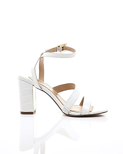 360 degree animation of product White asymmetric strappy block heel sandals frame-9