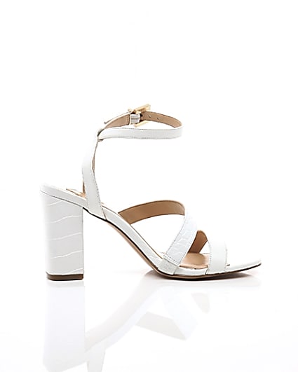 360 degree animation of product White asymmetric strappy block heel sandals frame-10