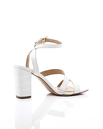 360 degree animation of product White asymmetric strappy block heel sandals frame-11