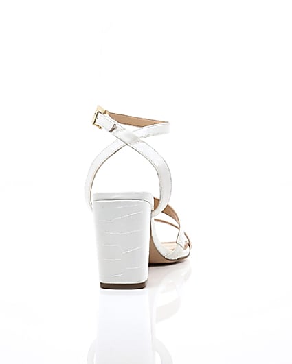 360 degree animation of product White asymmetric strappy block heel sandals frame-15