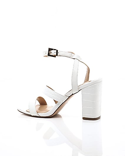 360 degree animation of product White asymmetric strappy block heel sandals frame-20