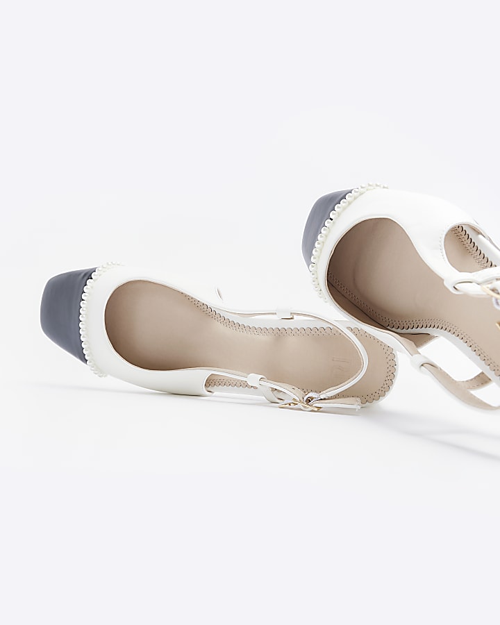 White heeled slingback shoes