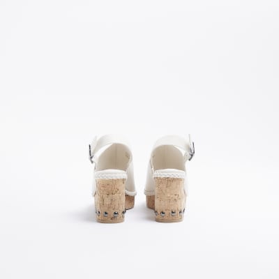 White platform heeled sandals