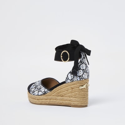 White RI monogram boucle wedges