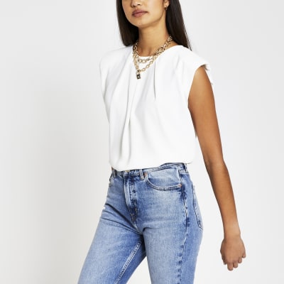 White sleeveless shoulder pad top